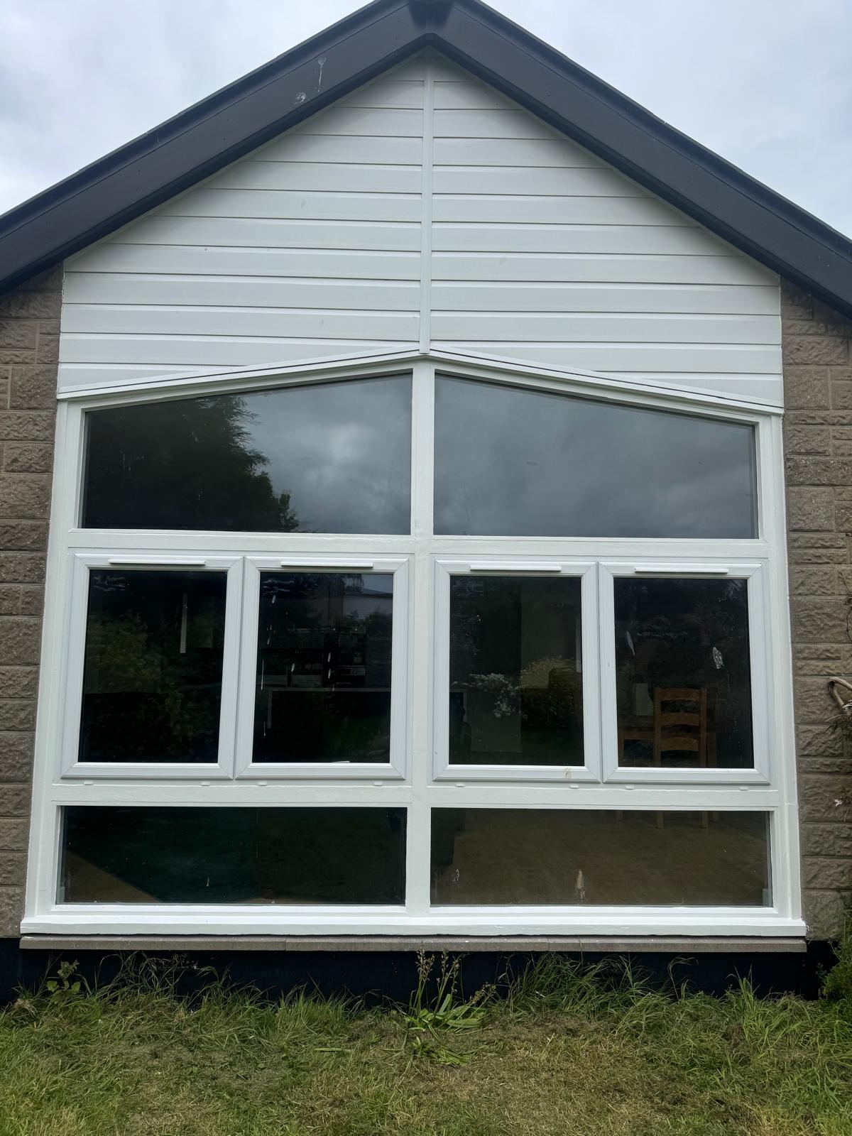 Large window with white frames and trim work