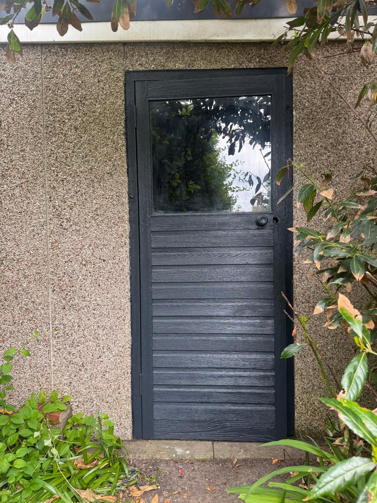 Dark painted exterior door with glass panel