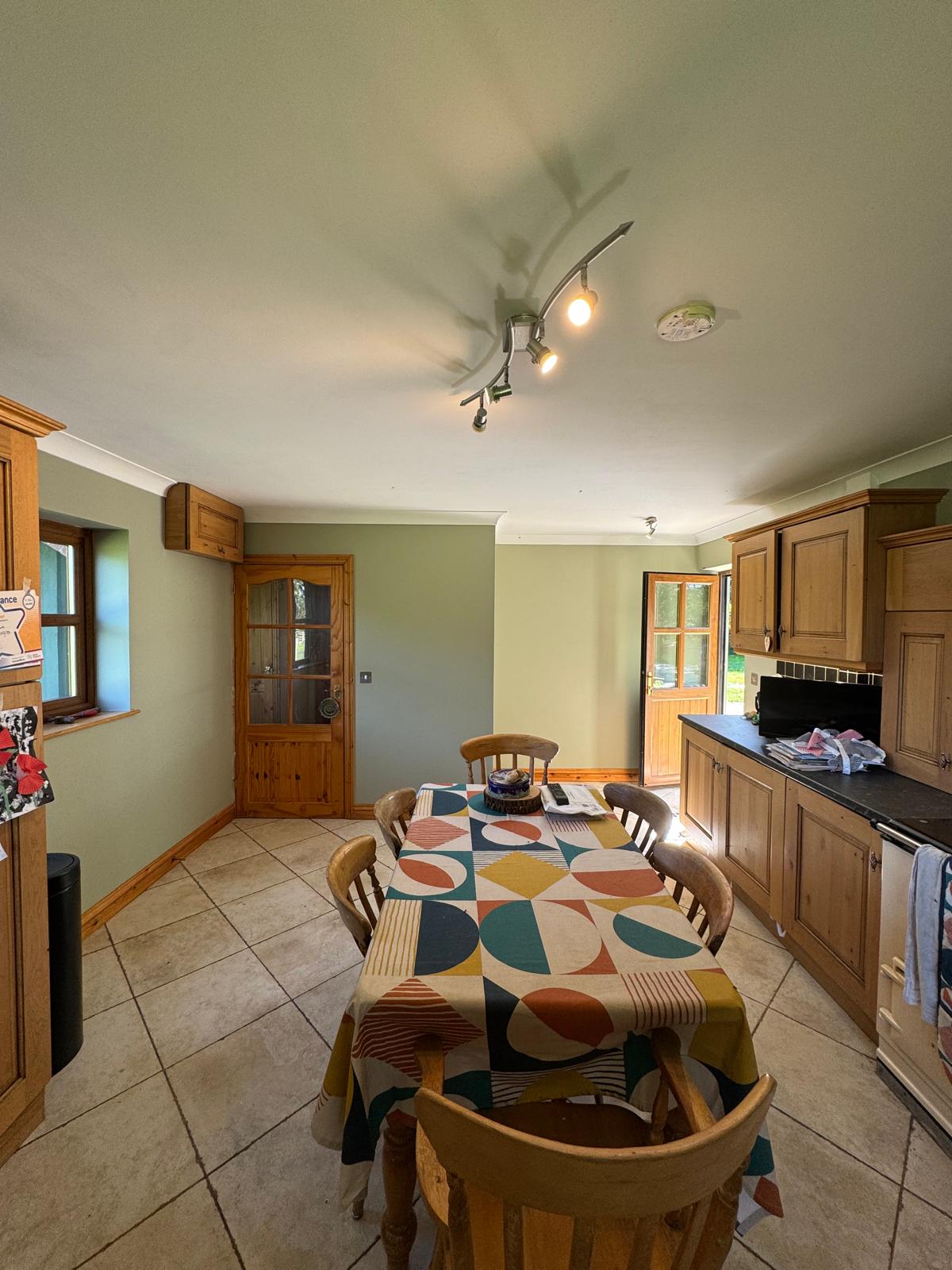 Kitchen dining area with sage green walls