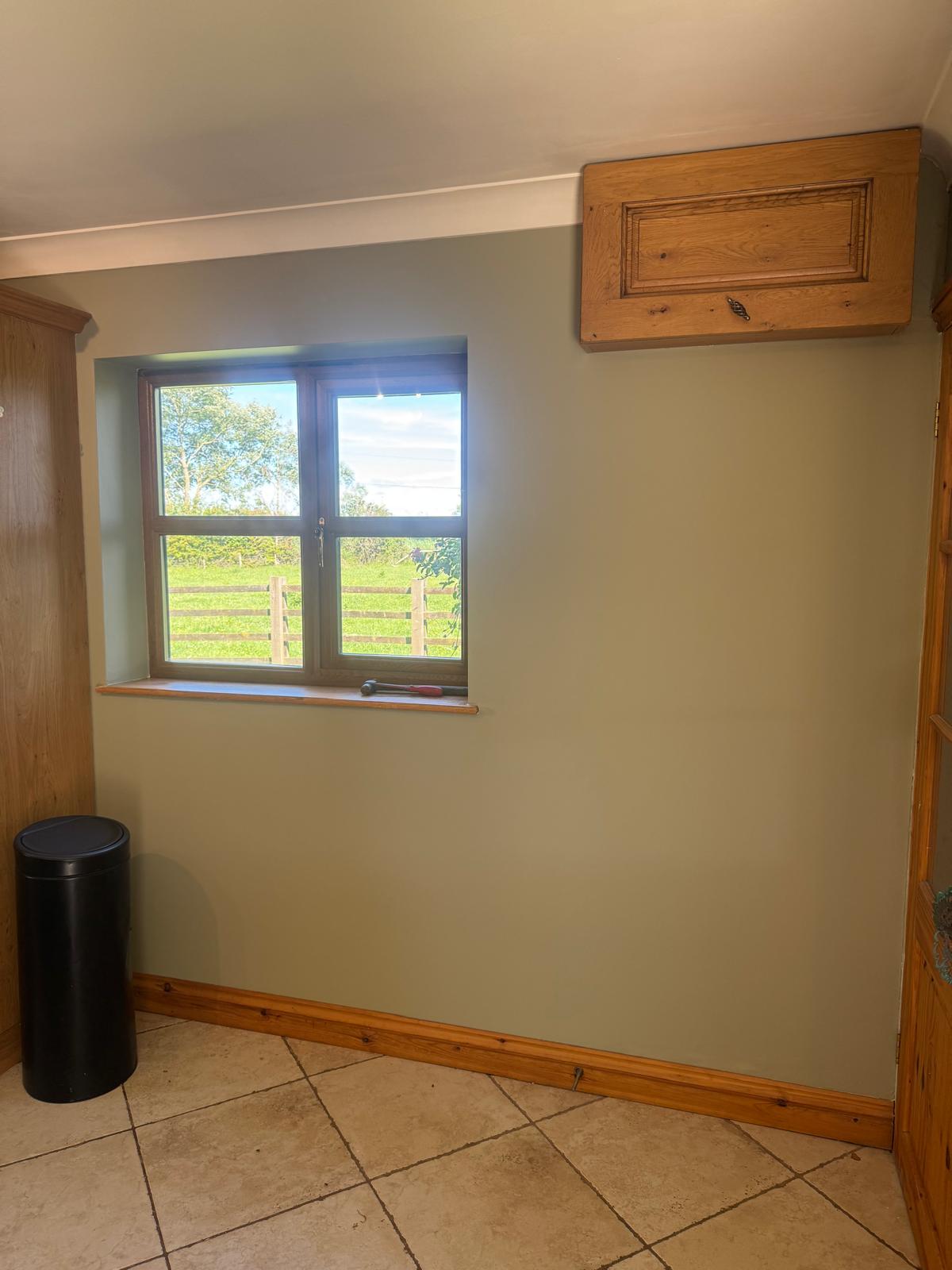 Kitchen nook with sage walls and window