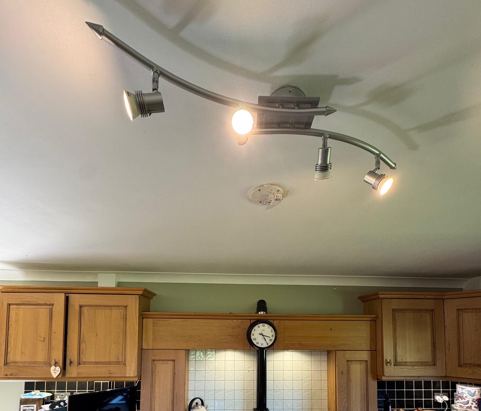 Kitchen ceiling with track lighting and wooden cabinets