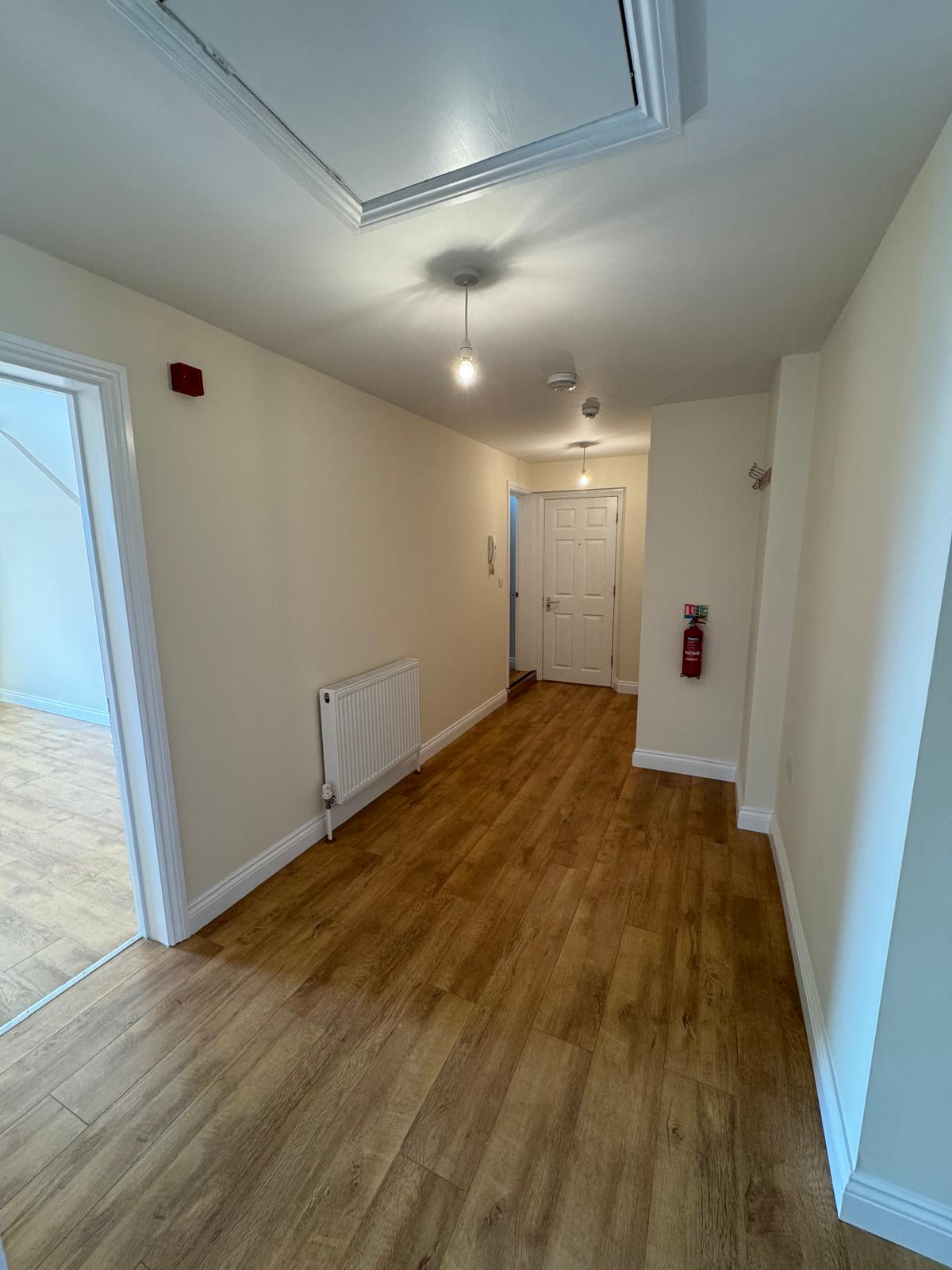 Hallway with cream walls and flooring