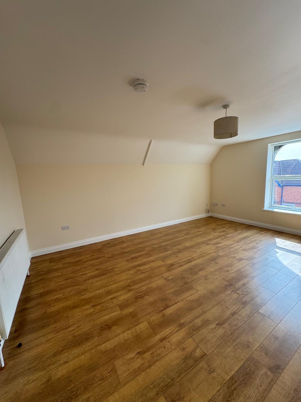 Room with cream walls, flooring and pendant light