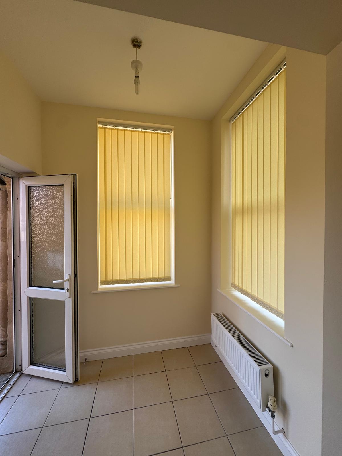 Small room with cream walls and yellow blinds