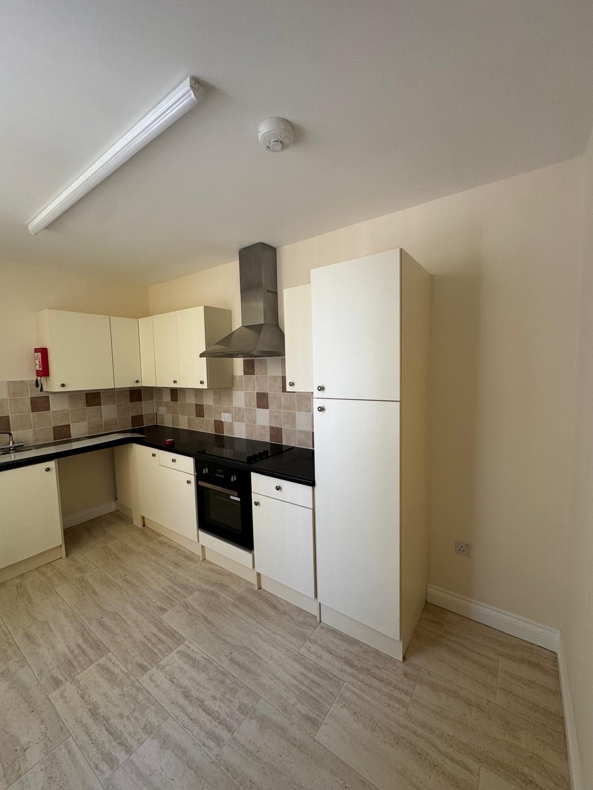 Kitchen with cream walls and white units